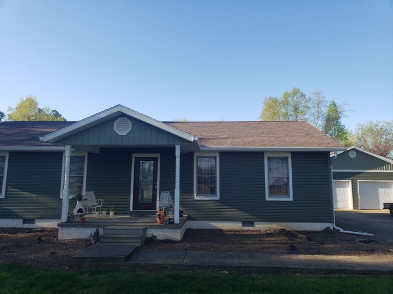 Closer view of new siding, windows, roof, and front entry details