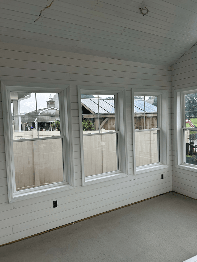 Interior view of newly installed sunroom windows during construction