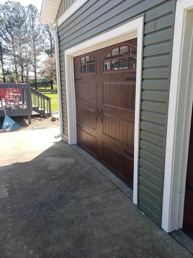 Interior view of a finished wood-look garage door and surrounding trim