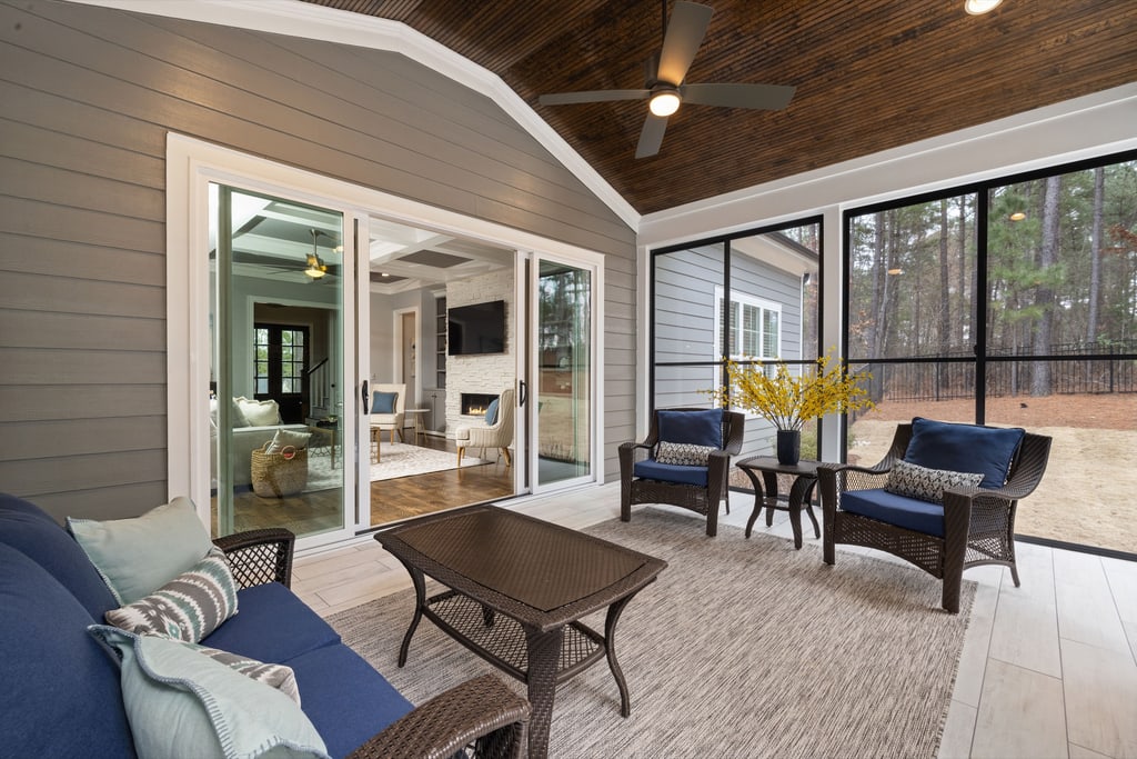 Screened living space with a vaulted wood ceiling and full-height screen panels